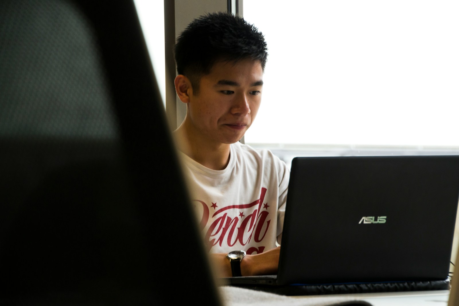 A concerned looking man sitting at a laptop